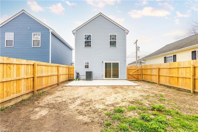 back of property with a patio area, central AC unit, and a fenced backyard