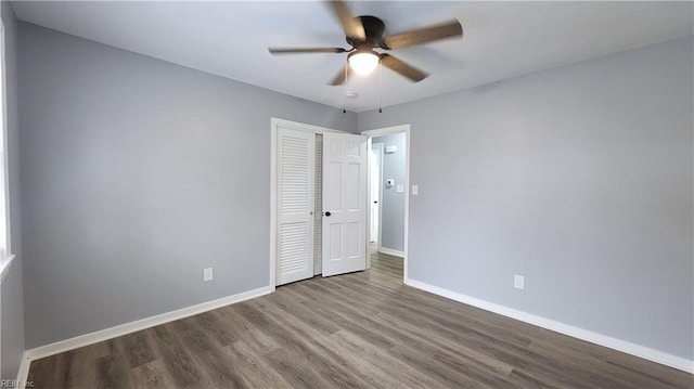 empty room featuring baseboards, ceiling fan, and wood finished floors