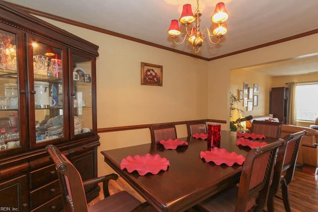 dining space with a chandelier, crown molding, and dark wood-style flooring