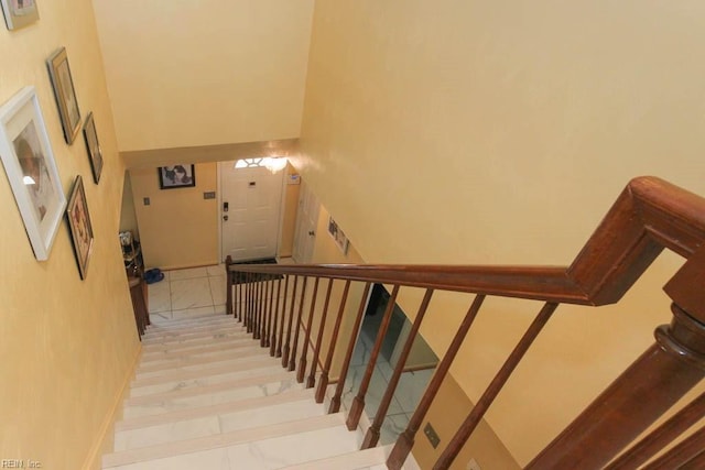 stairway featuring a high ceiling