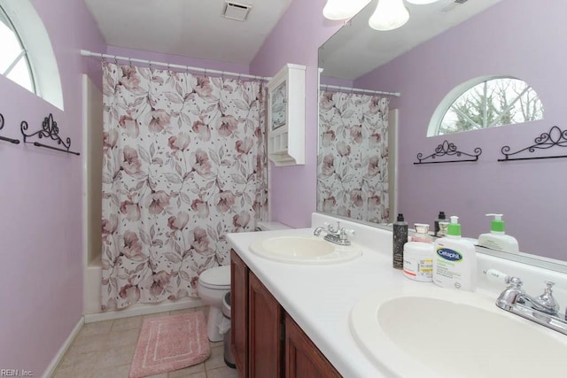 full bathroom with double vanity, toilet, visible vents, and a sink