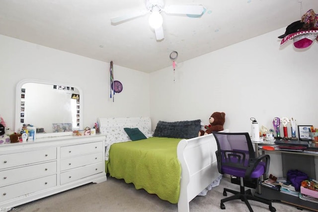 bedroom with a ceiling fan and light carpet