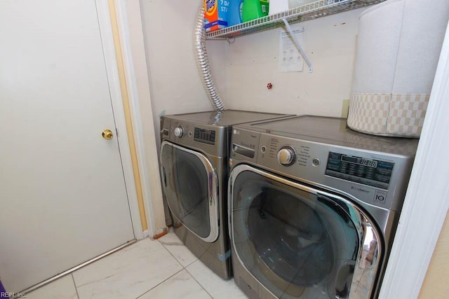 laundry room featuring laundry area, marble finish floor, and separate washer and dryer