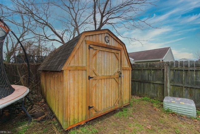 view of shed featuring fence