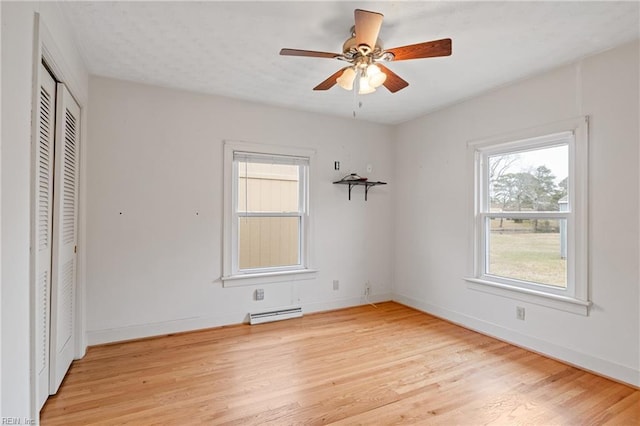 unfurnished bedroom with visible vents, baseboards, ceiling fan, a closet, and light wood-type flooring