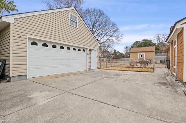 garage with driveway and fence