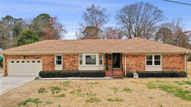 ranch-style home with a front yard, an attached garage, brick siding, and driveway