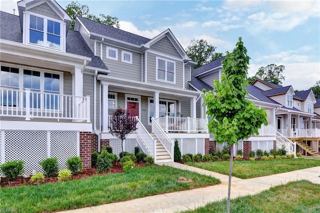 5311 Salzman St, Williamsburg, VA 23188 - view of front facade featuring stairs, covered porch, a shingled roof, and a front yard