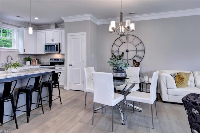 5311 Salzman St, Williamsburg, VA 23188 - dining area with a chandelier, light wood finished floors, crown molding, and recessed lighting