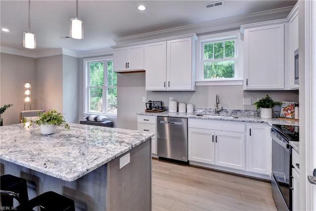 5311 Salzman St, Williamsburg, VA 23188 - kitchen with appliances with stainless steel finishes, a sink, white cabinetry, light wood-style floors, and crown molding