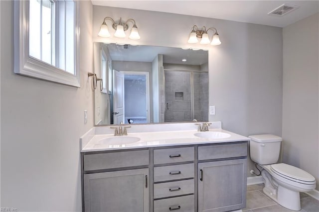 5311 Salzman St, Williamsburg, VA 23188 - full bathroom with toilet, a stall shower, double vanity, tile patterned flooring, and baseboards