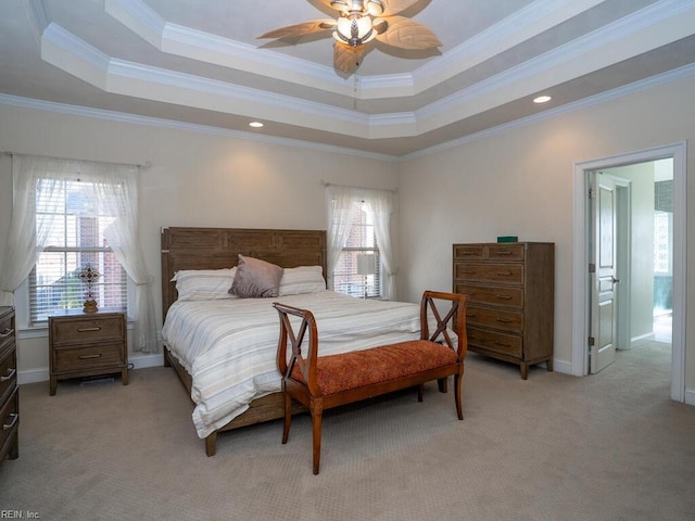 bedroom with light colored carpet, baseboards, crown molding, and a tray ceiling