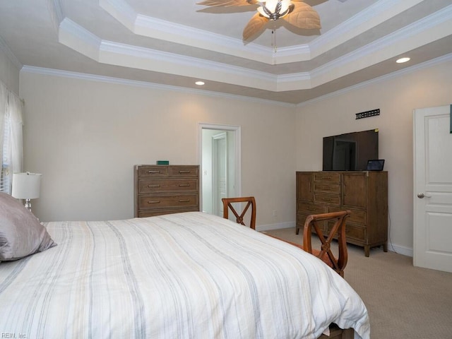 bedroom with light carpet, baseboards, a tray ceiling, and ornamental molding