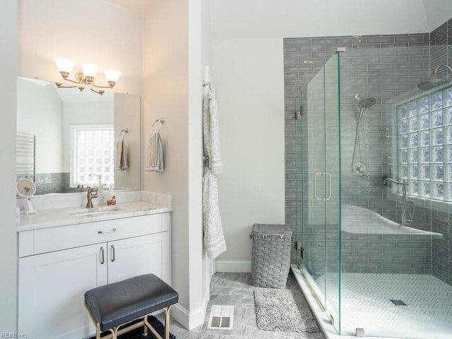 bathroom featuring a notable chandelier, visible vents, a stall shower, and vanity