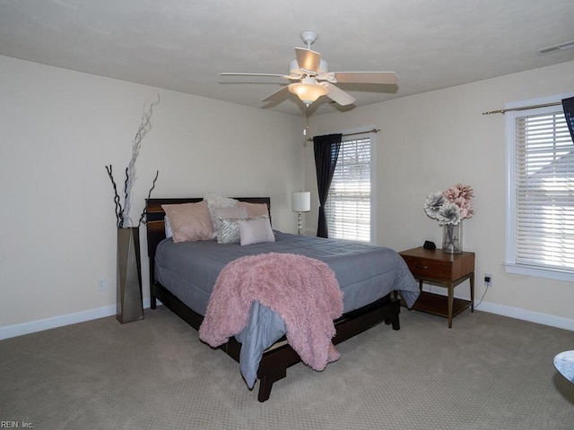 bedroom featuring baseboards, visible vents, carpet floors, and ceiling fan