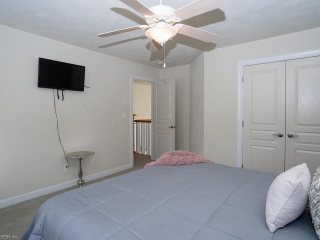 carpeted bedroom with baseboards, a closet, and ceiling fan