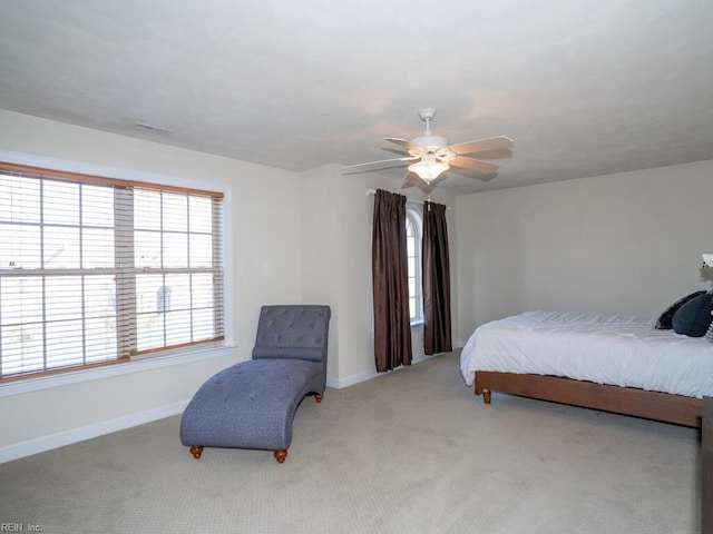 carpeted bedroom featuring baseboards and ceiling fan