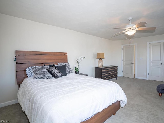 carpeted bedroom featuring a ceiling fan and baseboards