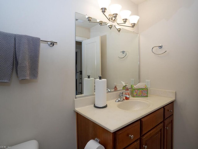 bathroom with vanity, an inviting chandelier, toilet, and visible vents