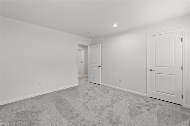 unfurnished bedroom featuring carpet flooring, recessed lighting, and baseboards