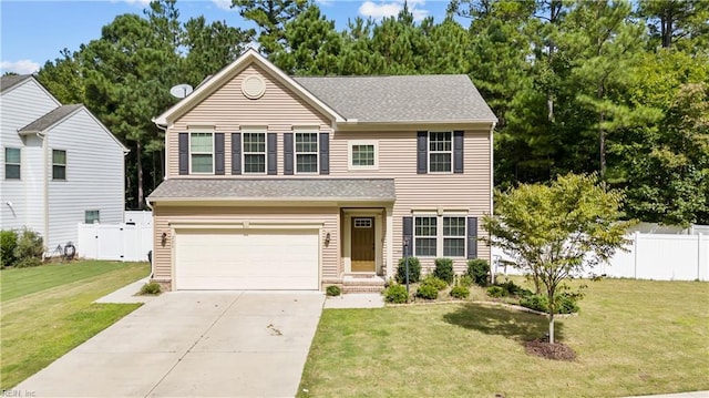 traditional home featuring a garage, driveway, a front yard, and fence