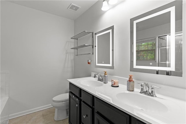 bathroom with a sink, visible vents, toilet, and double vanity