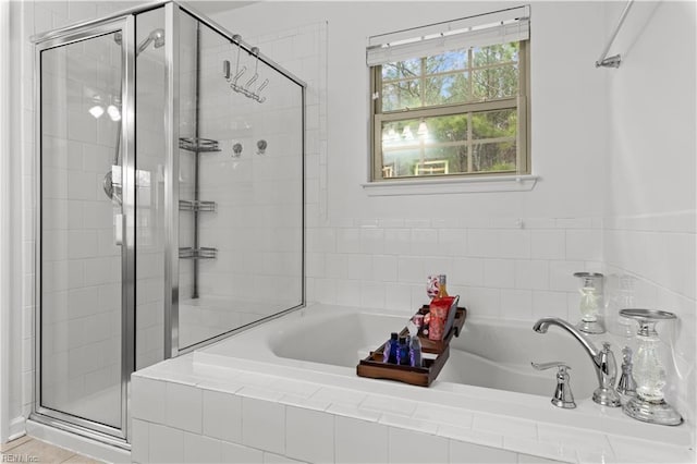bathroom with a shower stall and a garden tub