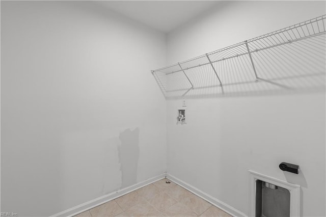 laundry area featuring laundry area, hookup for a washing machine, and baseboards