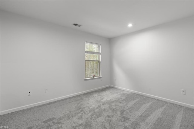 carpeted spare room with recessed lighting, visible vents, and baseboards