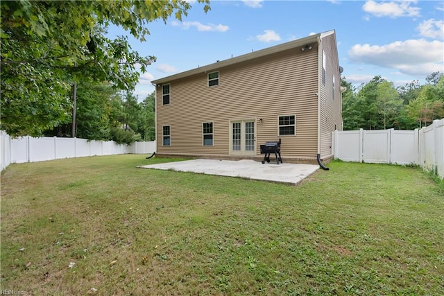back of property featuring a yard, a fenced backyard, and a patio