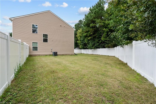 view of yard featuring central AC and a fenced backyard