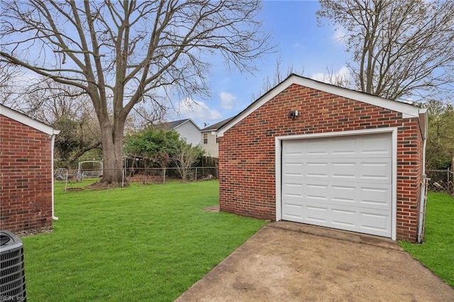 detached garage featuring cooling unit, driveway, and fence