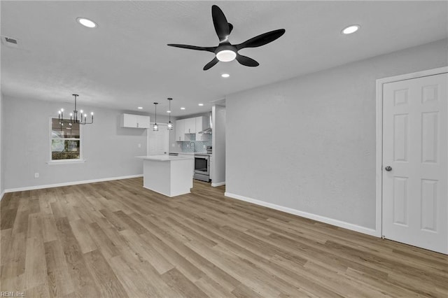 unfurnished living room featuring visible vents, ceiling fan with notable chandelier, recessed lighting, light wood-style floors, and baseboards