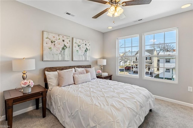 bedroom with visible vents, baseboards, ceiling fan, and carpet flooring