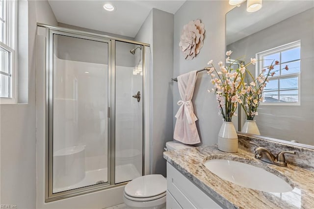 full bathroom with vanity, toilet, and a stall shower