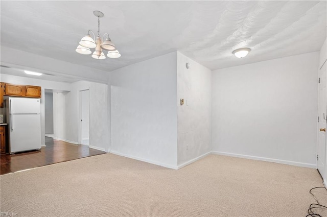 2118 Madison Ave, Newport News, VA 23607 - unfurnished dining area with baseboards, carpet flooring, and an inviting chandelier