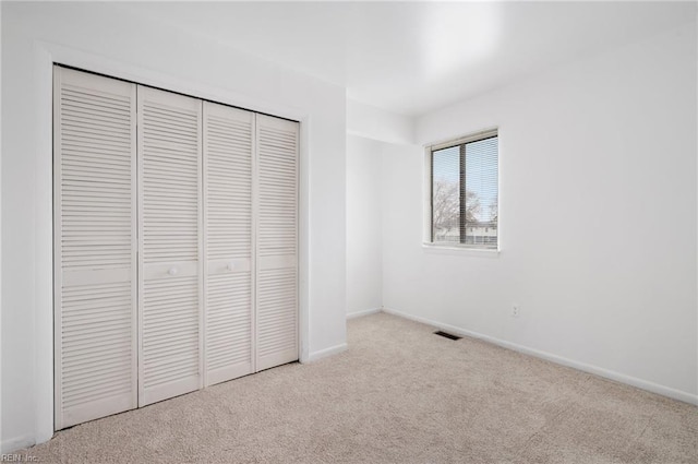 2118 Madison Ave, Newport News, VA 23607 - unfurnished bedroom featuring baseboards, visible vents, a closet, and carpet