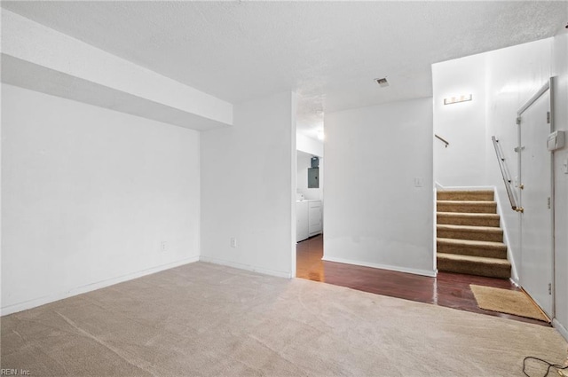 2118 Madison Ave, Newport News, VA 23607 - unfurnished living room featuring a textured ceiling, visible vents, stairway, and carpet