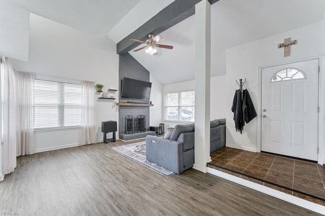 foyer with baseboards, wood finished floors, ceiling fan, and a fireplace