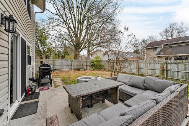 view of patio featuring area for grilling, an outdoor living space, and a fenced backyard