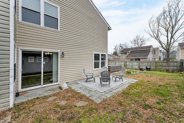 back of property featuring a patio area and fence