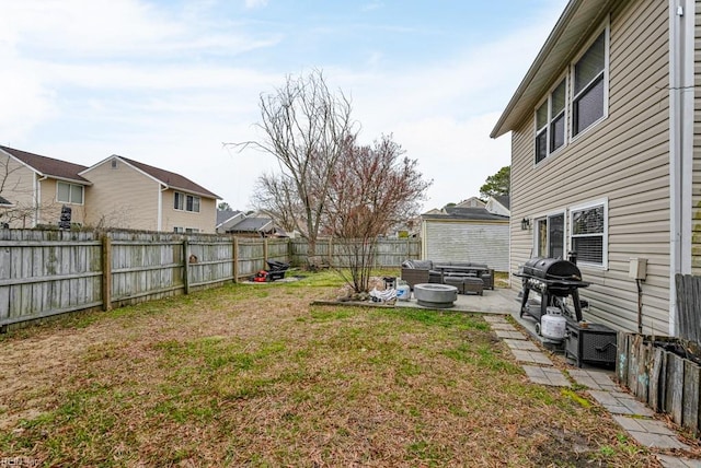 view of yard featuring a patio area, a fenced backyard, and an outdoor fire pit