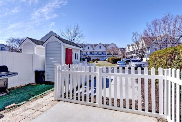 view of patio featuring a residential view, area for grilling, and fence