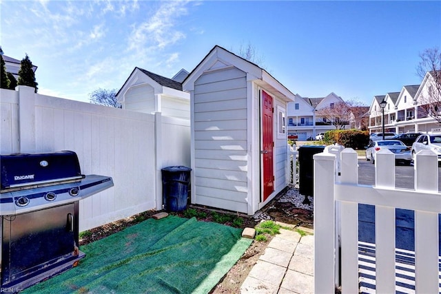 view of shed featuring a residential view and fence