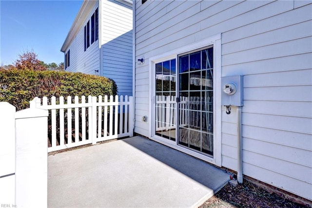 doorway to property with a patio and fence