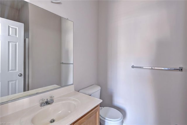 bathroom featuring toilet and vanity