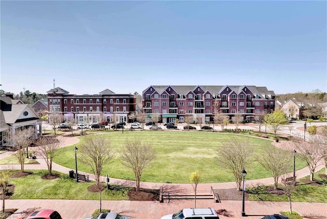 view of property's community featuring a yard