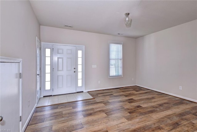 entrance foyer with visible vents, baseboards, and wood finished floors