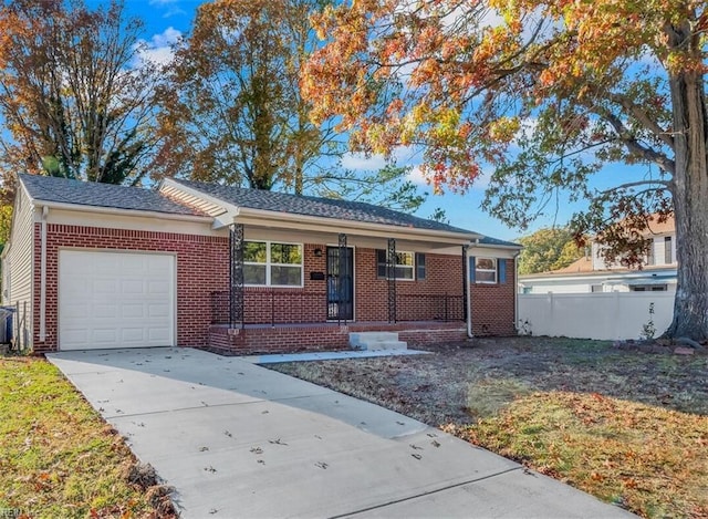 single story home featuring brick siding, fence, concrete driveway, a front yard, and a garage