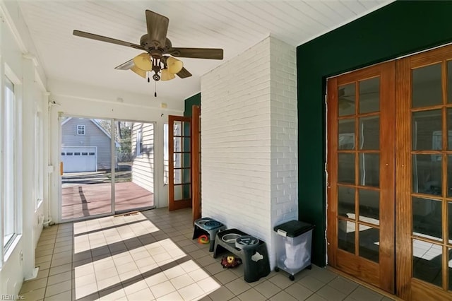 sunroom / solarium with a ceiling fan